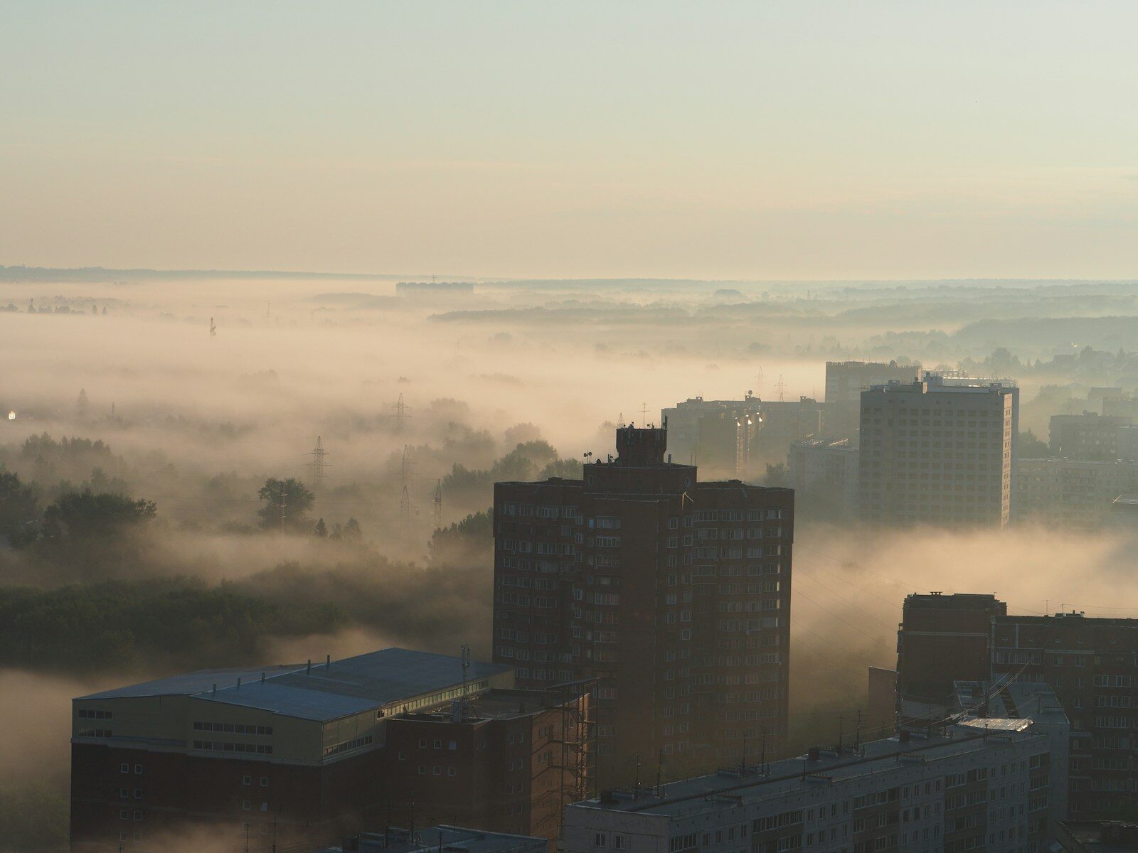 a view of a city in the middle of a foggy day